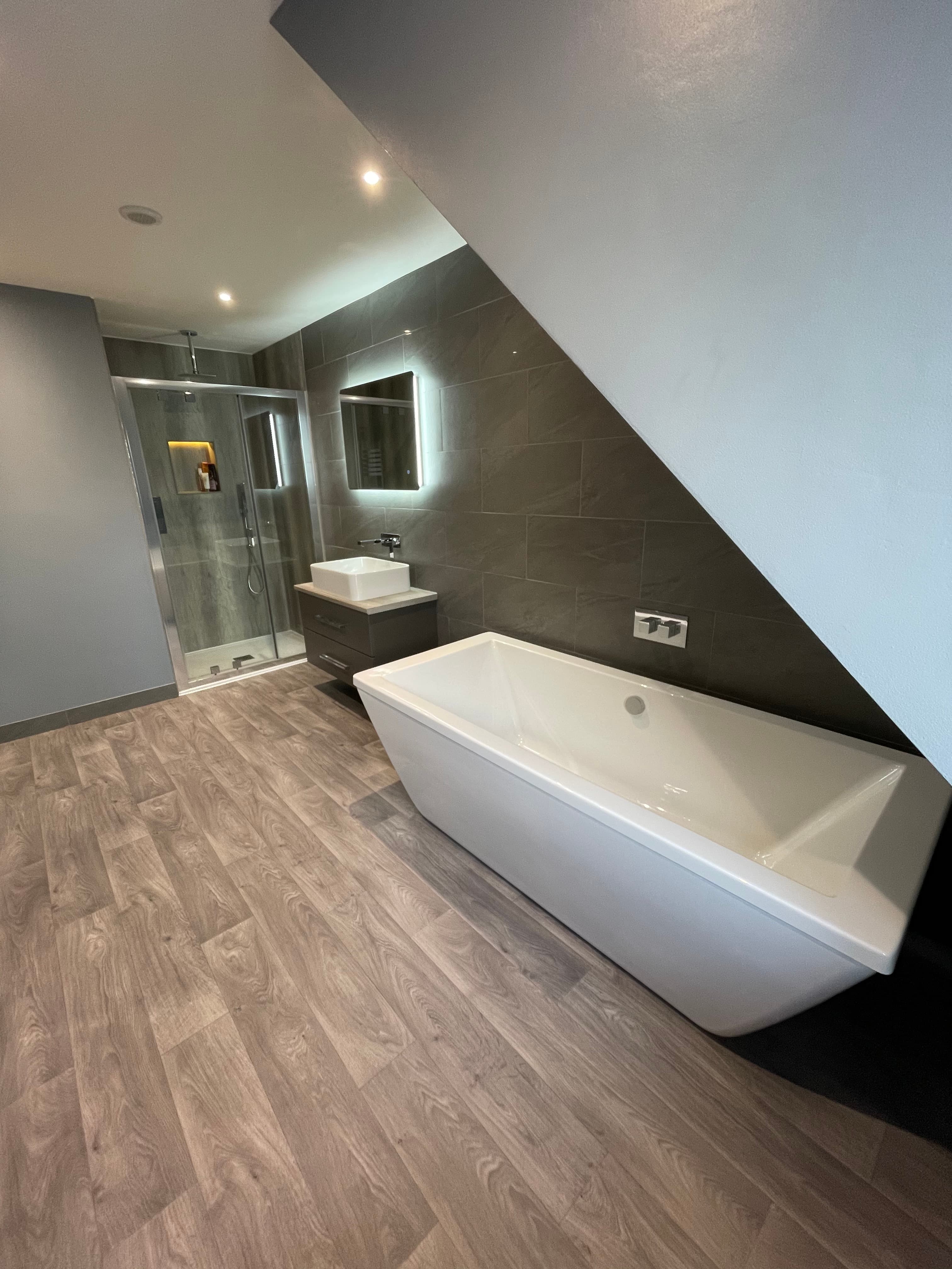 Contemporary bathroom fit-out with shower enclosure and floating vanity unit.