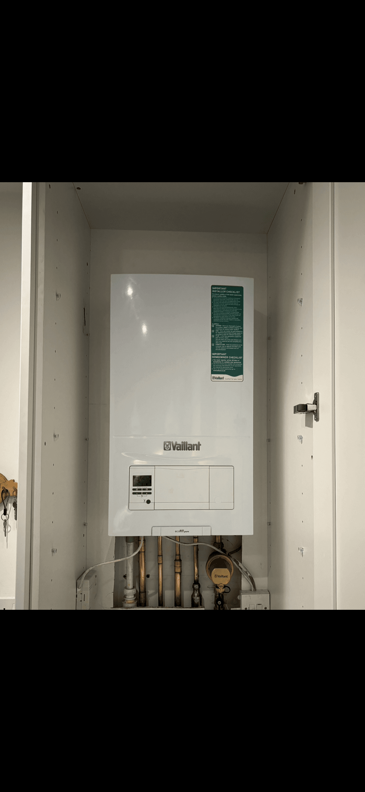 Neatly installed Vaillant boiler fitted inside a cupboard.
